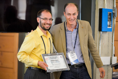 Thibault Fulconis, Vice Chairman and Chief Operating Officer for Bank of the West, presenting SnapCheck's President Ken Kruszka with BNP Paribas' International Hackathon presented by Bank of the West Award.