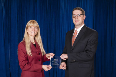 Dr. Maureen Hunter, president of the Society of Tribologists and Lubrication Engineers, presents the 2015 STLE Wilbur Deutsch award to Dr. Ryan Evans of The Timken Company. Dr. Evans and three other Timken associates co-authored a research paper on the root cause of smearing in wind turbine gearbox bearings.