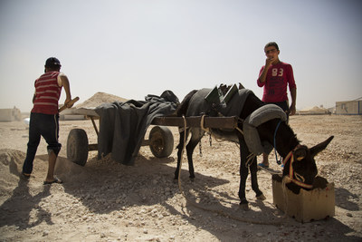 Children work in Za'atari camp digging sand to sell for building material. Photo by Rosie Thompson / Save the Children