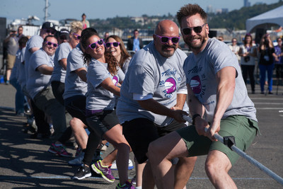Joel McHale pulls the plane during the Alaska Airlines Plane Pull competition against Russell Wilson, benefiting Strong Against Cancer at The Museum of Flight in Seattle on Tuesday, July 28, 2015. Team Wilson pulled the 737 in 16.9 seconds, with Team Joel coming in at over a minute.