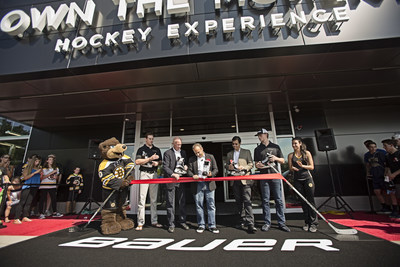 Buffalo Sabre Jack Eichel, and Boston Bruin Jimmy Hayes look on as Performance Sports Group CEO Kevin Davis cuts the ribbon at the grand opening of the Bauer Hockey OWN THE MOMENT Hockey Experience