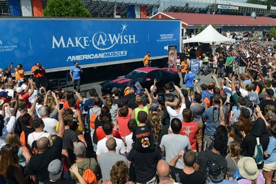 Steve Voudouris, president of AmericanMuscle.com, unveils the dream car of Johnathan Mullins -- in partnership with Make-a-Wish.