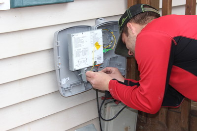 Tim Brown, Installation and Maintenance Technician for Midwest Connections, connecting fiber cable to Optical Network Terminal