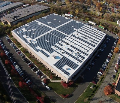Pfister Energy's Stackable Solutions. White energy efficient roofing system, solar photovoltaic array and prismatic skylights with integrated daylight harvesting LED lighting.