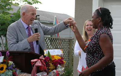 Les Muma, General Chairman of the 2016 Valspar Championship PGA golf tournament, presents Rolanda Lawrence with keys to the Habitat for Humanity home built by the Lawrence family and hundreds of volunteers from the Valspar Championship community, at a dedication ceremony in St. Petersburg, Florida on September 23, 2015.