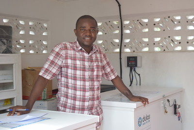In Ebola-affected Sierra Leone, Pharmacist Paul Borboh stands next to the clinic's new vaccine storage fridges that contain the first doses of Janssen's prime-boost vaccine regimen.