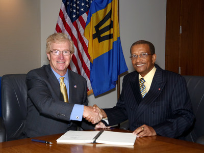 Stephen P. Holmes, Chairman and Chief Executive Officer, Wyndham Worldwide, and Everton Walters, Chairman, Barbados Tourism Investment Inc., finalize agreement to develop 450-room Sam Lord's Castle Barbados, A Wyndham Grand Resort.