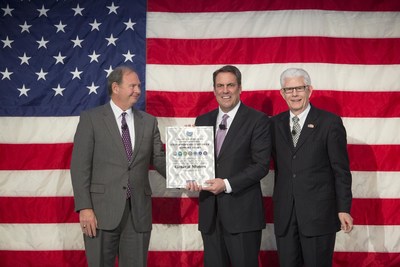 General Motors Executive Vice President Global Product Development, Purchasing and Supply Chain Mark Reuss (center) accepts the Employer Support of the Guard and Reserve Extraordinary Employer Support Award on behalf of GM during a Veterans Day celebration Tuesday, November 10, 2015 in Warren, Michigan. General Motors reaffirmed its commitment to employees serving in the National Guard and Reserve during the event. The award recognizes sustained commitment of companies for employees in the National Guard...