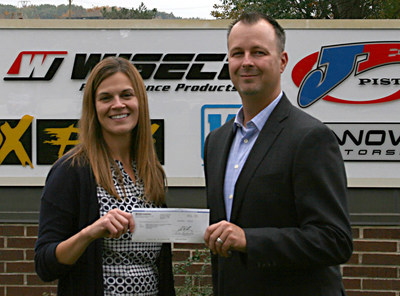Performance Motorsports International CFO, Michael Dudiak, presents Keri Haibach of Make-A-Wish Foundation of Ohio, Kentucky, and Indiana with a $10,000 donation.