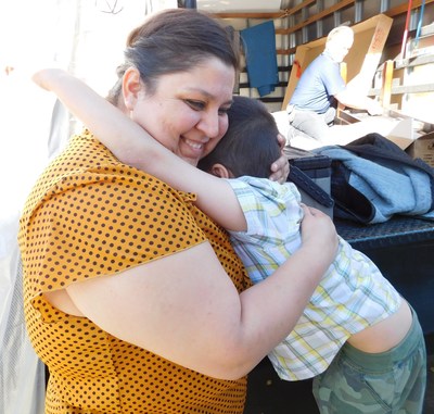 Maria Sahagun hugs her son with excitement as Aaron's, Inc. associates deliver furniture to fill her entire home on Friday, November 20, 2015, in Rialto, California. Aaron's, Inc., a leader in the sales and lease ownership and specialty retailing of furniture, consumer electronics, home appliances and accessories, in partnership with Univision Network's "Despierta America," surprised Sahagun with new furniture, a prize package valued at more than $24,000, as a part of the first "Despierta En Tu Nuevo Hogar" (Wake Up in Your New Home) contest.