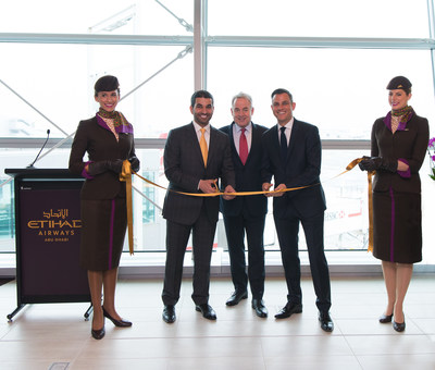 Etihad Airways President and Chief Executive Officer James Hogan is joined in a ribbon-cutting ceremony inaugurating the airline's new premium First and Business Class Lounge at New York's John F. Kennedy International Airport by Hareb Almuhairy, Senior Vice President, Corporate and International Affairs (L), Martin Drew, Senior Vice President, The Americas (R) and Etihad Airways' cabin crew.