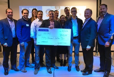 FitPay's CEO & Co-Founder Michael Orlando receives a $50,000 check for winning the Comerica RocketSpace Wearable FinTech Challenge.