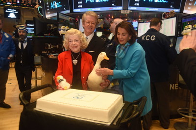 Aflac Chairman and CEO Dan Amos and Aflac Foundation President Kathelen Amos look on as Jean Amos, the wife of Aflac co-founder Paul S. Amos, cuts the cake at the company's 60th anniversary celebration at the NY Stock Exchange.
