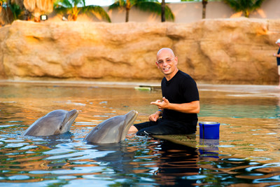 Host Anthony Melchiorri swims with dolphins in the Bahamas