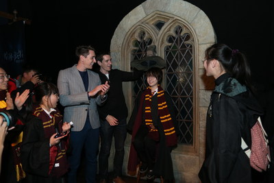 James and Oliver Phelps sort a fan into his Hogwarts house at the opening of Harry Potter: The Exhibition in Shanghai, China.