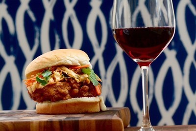 Southern fried chicken sandwich topped with kimchi cabbage slaw paired with Nero d'Avola. Look for Sicilia DOC on the label at local grocery and beverage shops.