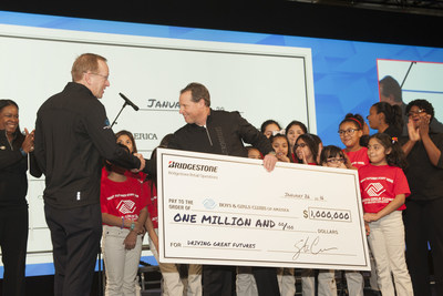 Stu Crum, president of Bridgestone Retail Operations (BSRO), presents Jim Clark, president and CEO of Boys & Girls Clubs of America, with a check for $1 million at the BSRO National Business Conference in Houston on Jan. 26, 2016.