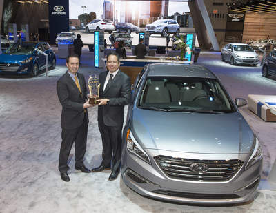 Left to Right: Steve Lind, executive vice president, operations, Cox Automotive Media, presents Brandon Ramirez, senior group manager, product planning, Hyundai Motor America, the trophy for Hyundai as the overall brand winner in the 2016 Kelley Blue Book 5-Year Cost to Own Awards at the 2016 Chicago Auto Show.
