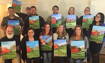 A group of wounded veterans and their guests share time and talent while painting.