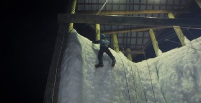 An injured service member scales new heights to independence on the ice wall.
