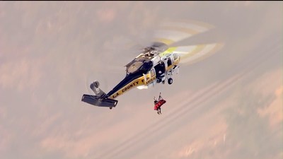 In a dramatic rescue, the County of Los Angeles Fire Department Aviation Unit hoists the driver from the crash site in a Sikorsky S-70A FIREHAWK. [Photo credit: KTLA News]
