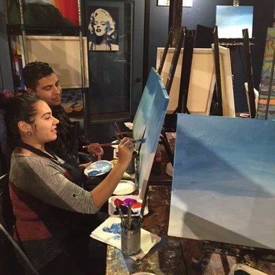 Wounded veterans spend time together painting.