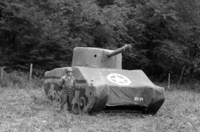 A Ghost Army soldier with an dummy M4 Sherman Tank, 93 pounds fully inflatable, September 1944, France. Courtesy: National Archives.