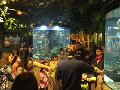 Wounded Warrior Project Alumni and their families explore the fishtanks at the Kemah Aquarium, during an Alumni Program event.