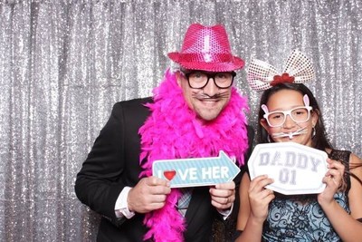 Wounded veterans and their daughters enjoy the photo booth at Daddy and daughter dance.