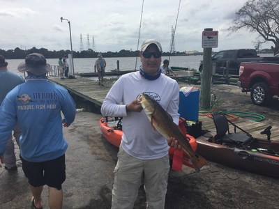 WWP Alumni catches fish during kayak fishing event.