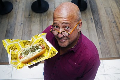 Aramark, the award-winning food and beverage partner at eight MLB stadiums, today announced an expanded partnership with Andrew Zimmern. The three-time James Beard Award-winning TV personality, chef and teacher developed four signature items exclusively for Aramark's menus this baseball season, including AZ's Canteen Dog, pictured here, held by Zimmern.