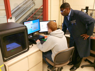 Demetrius Wilson, instructor at Oakland Schools Technical Campus Northeast in Pontiac, Michigan, works with students to learn about the Afinia 3D printer given by SME.
