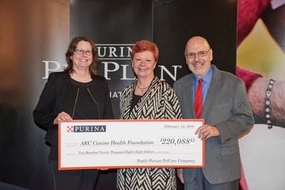 Ann Viklund, Purina Director of Conformation, center, presents the 2015 PPCP donation to Dr. Diane Brown, CEO, and Dr. Duane Butherus, chair, of the AKC Canine Health Foundation.
