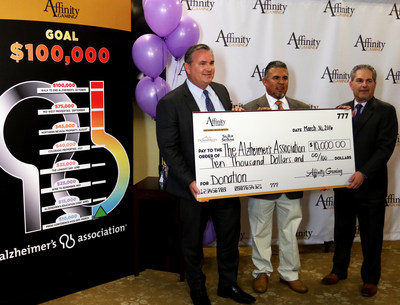 Affinity Gaming CEO Michael Silberling (L) and Affinity Gaming General Council and Secretary Marc Rubinstein (R) present Alzheimer's Association Desert Southwest Chapter Regional Director Albert Chavez (M) with the first $10,000 check to kick off Affinity Gaming's $100,000 commitment to the Alzheimer's Association. The gaming company has pledged to contribute at least $100,000 to the Association's regional chapters where its 11 casinos are operated across Southern and Northern Nevada, Colorado, Missouri and Iowa.