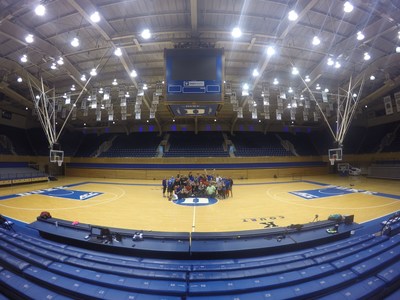 Wounded Warrior Project injured veterans huddle on the court at Cameron Indoor Stadium at Duke University.