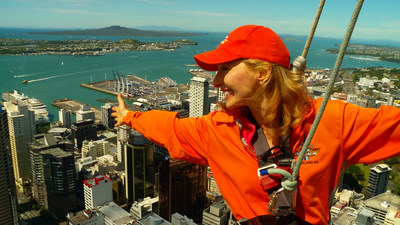 Host Linda Swain walks around the outside of the Skytower, the tallest building in the Southern Hemisphere.