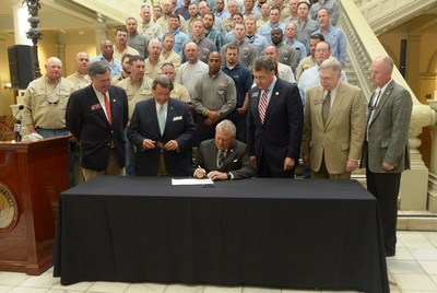 Governor Nathan Deal marks Lineman Appreciation Month by signing House Bill 767 into law Tuesday. The legislation adds utility vehicles and workers to an existing law which requires drivers to 