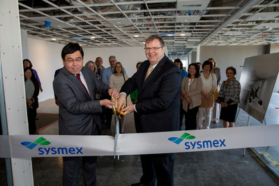 John Kershaw, right, President and CEO, Sysmex America, Inc, cuts a ribbon with former Sysmex America CEO and Executive Vice Chairman Kazuko Obe, now with Sysmex Corporation, at the ribbon cutting to celebrate Sysmex's opening of an office in Irvine, Ca.