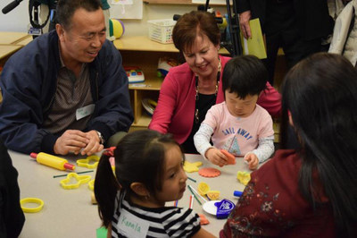 National Center for Families Learning President and CEO Sharon Darling works with Jasmine He and her grandfather Yun Tong at a recent unveiling of Toyota Family Learning in Louisville, Ky.
