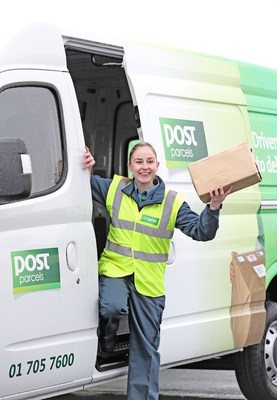 Dublin Postwoman with one of the An Post postal delivery vehicles in which the Fleetmatics solution will be fitted.