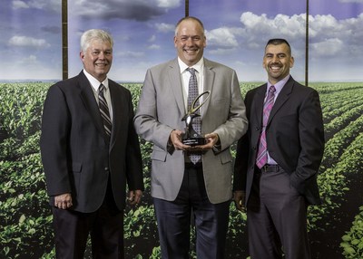 Pictured are Valspar employees Keith Foehkolb (left) and Jerimy Erickson (middle) with the John Deere supplier innovation award from Kevin Hernandez (Deere and Company) following a formal ceremony in Moline, Illinois. The award is presented to a select group of suppliers who have demonstrated innovation in the product or service they provide to John Deere.