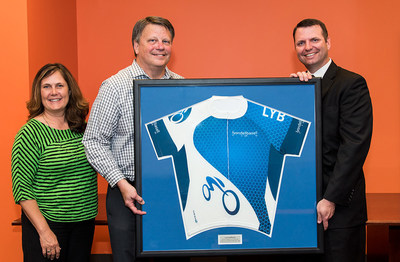 Kelli Dreiling, National MS Society vice president of development, and Mark Neagli, president of South Central Region MS Society, are presented with a LyondellBasell cycling team jersey from Jim Guilfoyle of LyondellBasell on Wednesday, April 27, 2016, in Houston. LyondellBasell received the Society's Circle of Distinction Award for raising $1.4 million through participation in the annual BP MS 150 bike ride. The jersey will hang in the Hall of Fame at the National MS Society offices in Houston.