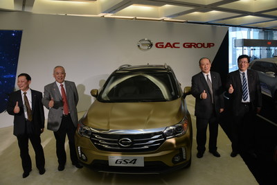 GAC Motor executives stand around the company's GS4 SUV that made its world debut at the 2015 North American International Auto Show.