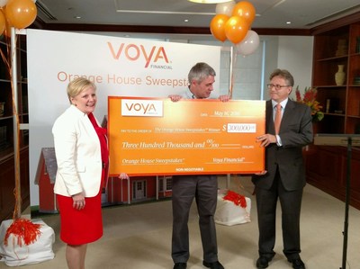 Voya executives Karen Eisenbach (left) and Alain Karaoglan (right) help Orange House Sweepstakes™ winner Kevin Martin (center) build a solid foundation for his retirement with a $300,000 prize.