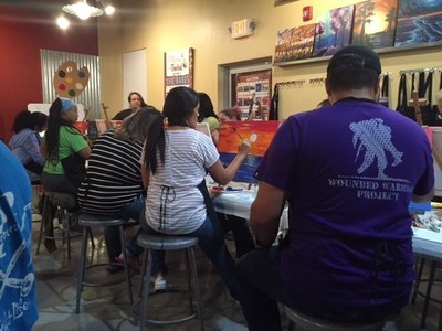 Wounded Warrior Project brings wounded veterans and families together to paint at Alumni event.