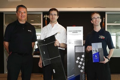Standing with the Louis Schwitzer Award trophy (left to right) were award winners Tino Belli from INDYCAR, Arron Melvin from Chevrolet, and Alex Timmermans from Dallara for the Rear Beam Wing Flap.