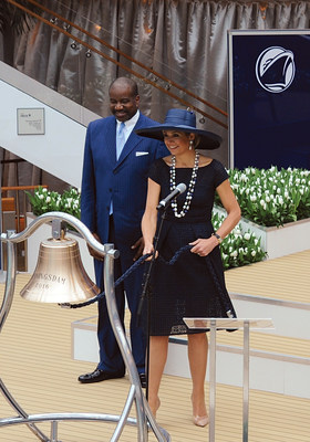 Her Majesty Queen Maxima of the Netherlands rings the bell of ms Koningsdam - the newest cruise ship for Carnival Corporation and one of its 10 brands, Holland America Line - after officially blessing the bell with a glass of champagne, with Orlando Ashford, president of Holland America Line, watching her do the honors.
