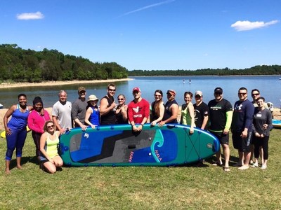 Wounded veterans and their families try stand up paddle boarding.