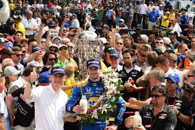 Standing beside the Borg-Warner Trophy(TM) in Victory Lane, BorgWarner President and Chief Executive Officer James Verrier congratulated Alexander Rossi on his victory at the 100th running of the Indianapolis 500. Photo courtesy of Robert Banayote for BorgWarner.