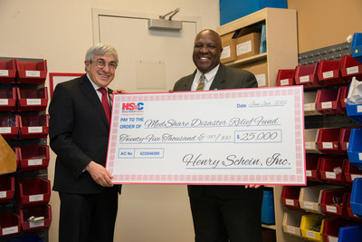 Stanley M. Bergman, Chairman of the Board and Chief Executive Officer of Henry Schein, presents Charles Redding, Chief Executive Officer and President of MedShare, with a $25,000 donation to become the first corporate sponsor of MedShare's newly created Disaster Relief Fund.